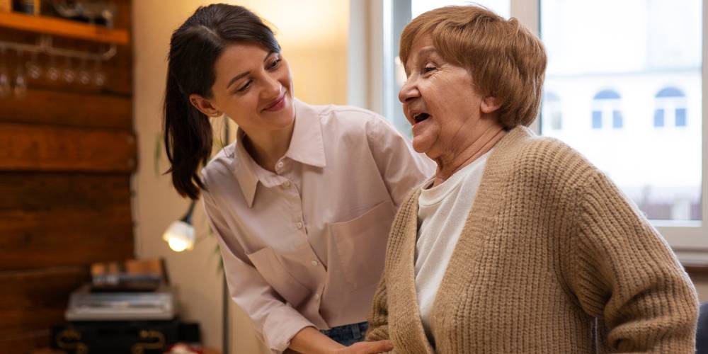 A friendly support worker from our Braybrook team having a conversation with a SIL participant.