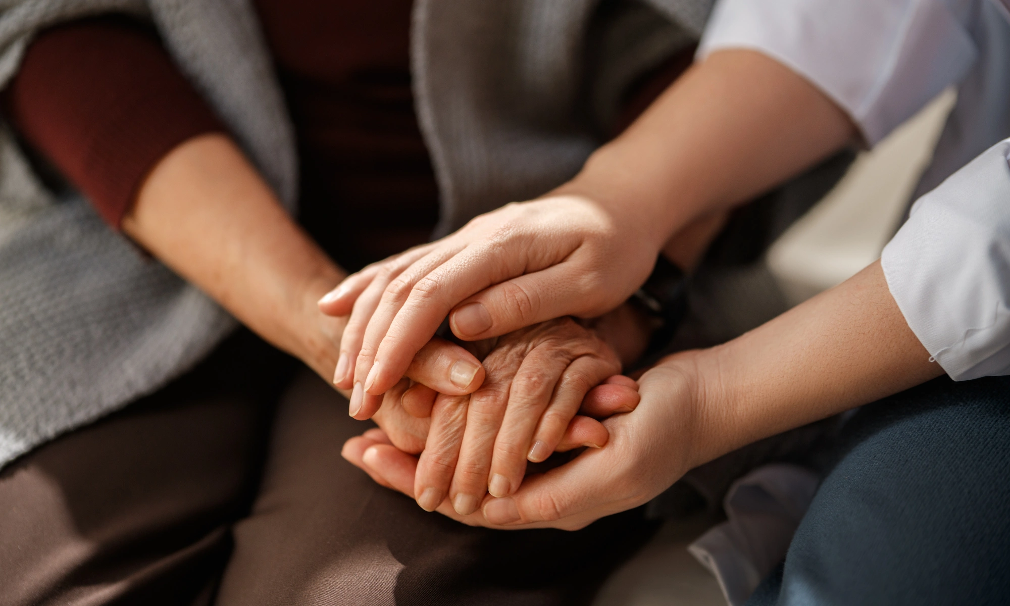 Caring Hands Offering Comfort and Support to Elderly Person