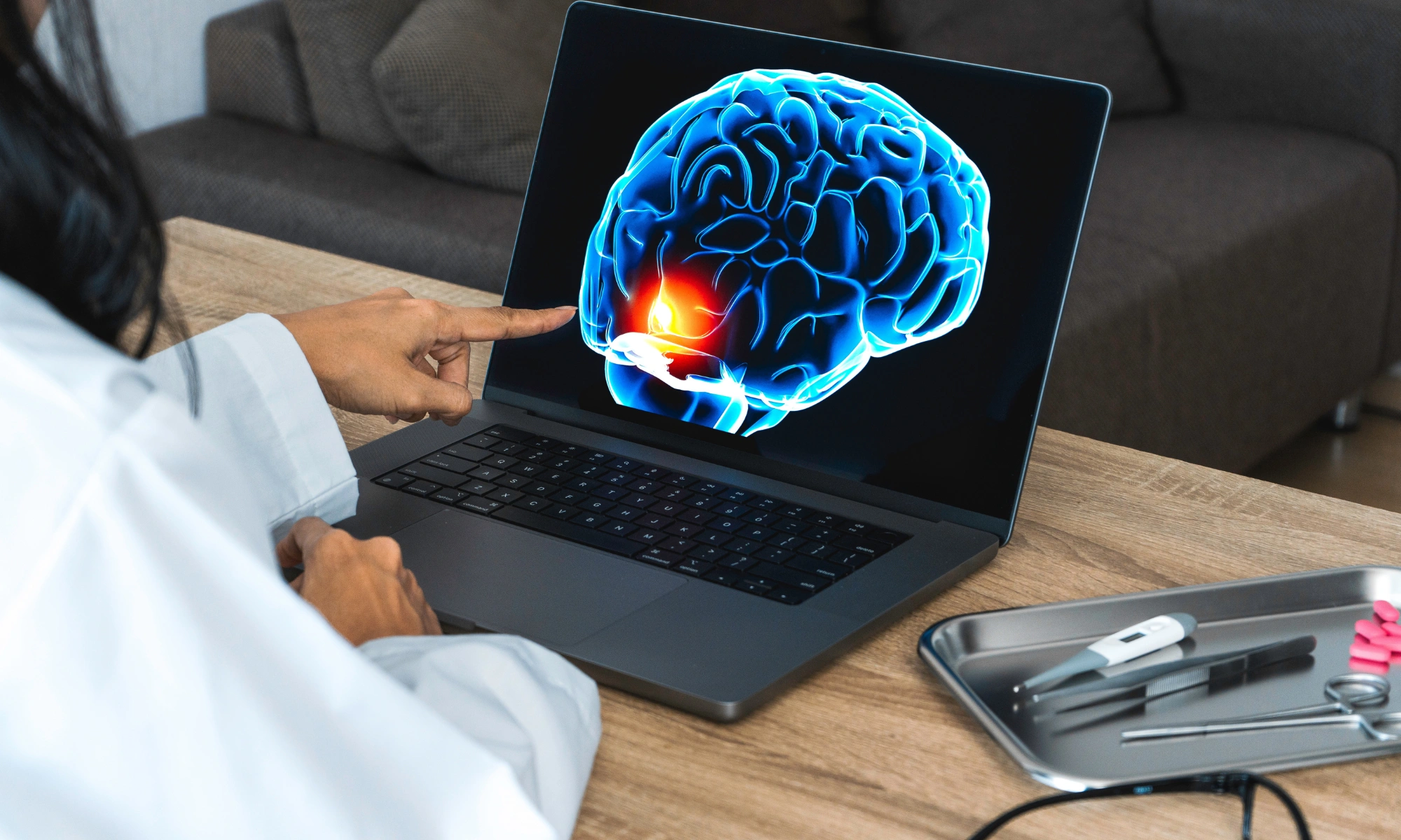 Doctor showing a x-ray of pain in the brain on a laptop.